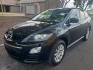 2012 black /gray and black Mazda CX-7 i Sport (JM3ER2BM9C0) with an 2.5L L4 DOHC 16V engine, 5-Speed Automatic transmission, located at 323 E Dunlap Ave., Phoenix, AZ, 85020, (602) 331-9000, 33.567677, -112.069000 - 2012 Mazda CX-7 i Sport,…….Ice Cold A/C, Clean gray and black interior with black cloth seats in good condition, New brakes, Tune up, Stereo/CD Player, Bluetooth, Phone sync, Satellite compatible, This SUV is gorgeous inside and out, Incredible gas mileage! Arizona title , Runs and Drives Excel - Photo#0